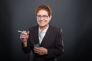 Business senior lady holding cigarrete and box
