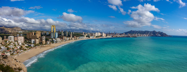 Panoramic view Benidorm with high buildings, mountains and sea - obrazy, fototapety, plakaty