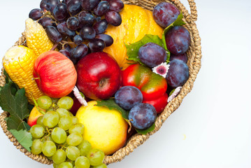 Healthy food Concept Composition with Vegetables and Fruits in Rustic Basket Isolated on White.