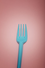 cyan fork on pink background 
