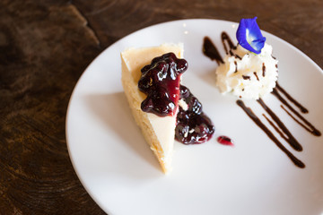 sweet cake with Blueberry toping in dish on table wood