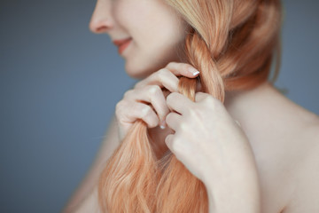 close up woman hands braiding hair, sensual look studio portrait beauty