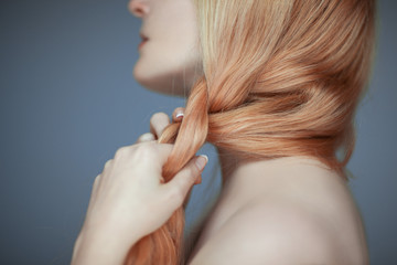 close up woman hands braiding hair, sensual look studio portrait beauty