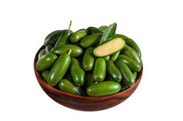 Fresh seedless cocktail avocado with one cutted in the bowl isolated on white background. Cucumber or cocktail avocado without any seed. New genetic gift for avocado fans.