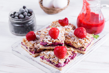 Homemade shortcrust fruit pie with crumble on white background - homemade pastry with strawberry