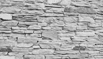 High quality grey stone wall texture. Natural cobblestone road as background.