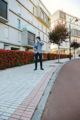 Fototapeta premium Businessman talking on the mobile in the street