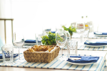 Restaurant table set with glasses, napkins and cutlery