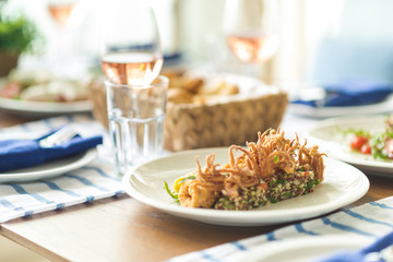 Restaurant table set with glasses, napkins and cutlery