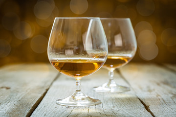 Cognac in glasses on rustic backgrpund