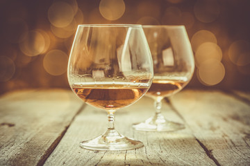 Cognac in glasses on rustic backgrpund