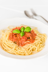 tatsty fresh spaghetti with tomato sauce fresh basil isolated on white background