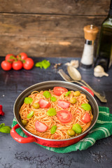 Spaghetti pasta with tomato sauce  and fresh basil - homemade healthy italian pasta on rustic wooden background