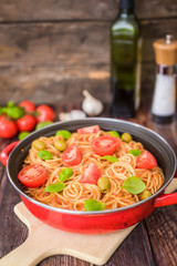 Spaghetti pasta with tomato sauce  and fresh basil - homemade healthy italian pasta on rustic wooden background