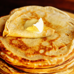 Stack of Russian-style pancakes with raspberries