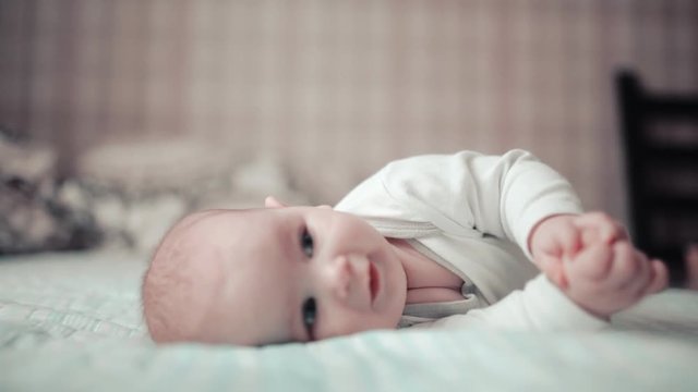 little baby crawling on bed