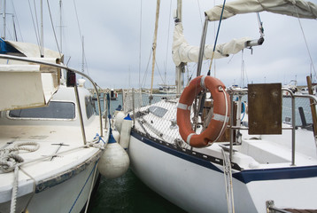 Boat In Valencia Port At Mediterranean Sea. Reflexion in the water. White yacht are in the Spanish...