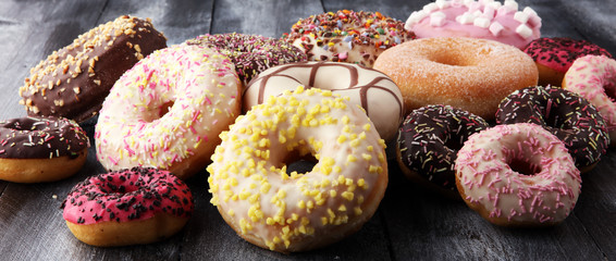 assorted donuts with chocolate frosted, pink glazed and sprinkles donuts. - 190226580