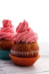 Tasty cupcakes on wooden background. Birthday cupcake in rainbow colors