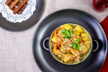 Pork stew served with cooked potatoes