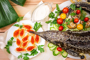 The stuffed sturgeon baked on a platter