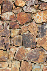 Brown stone surface of wall background.