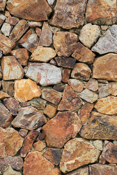 Brown stone surface of wall background.