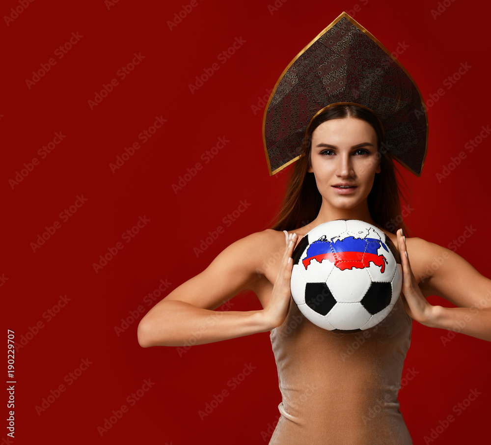 Wall mural Ruusian style Fan sport woman player in kokoshnik hold soccer ball celebrating happy smiling laughing