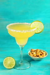 Margarita cocktail on blue background with copyspace