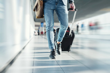 Man with hand luggage walking in airport