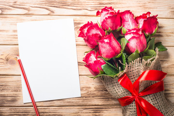 Red rose flower on wooden table. 