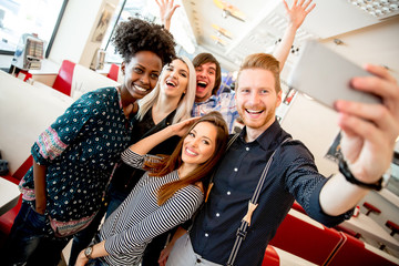 Group of young people taking selfie with mobile phone