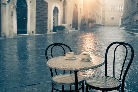 Rainy street cafe in old European town
