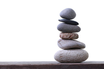 Balance Stones stacked placed on a wooden floor.