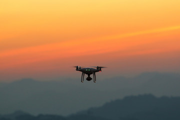 Fototapeta na wymiar Silhouette drones.Drone flying in the sunset