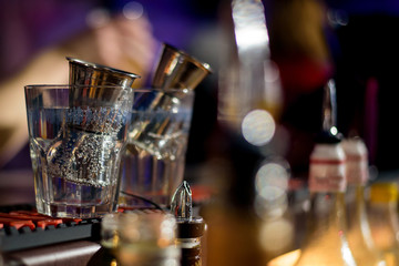 Alcohol bar, cocktail glass on bar counter, cocktail glass in a bar, Drinking cocktail in bar, cocktail in the glass with straws, Fresh drink coctail on a color background