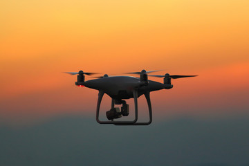 Fototapeta na wymiar Silhouette drones.Drone flying in the sunset