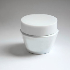 White jar for cream. The container for the cosmetic oils and creams.