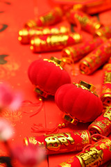 Fototapeta premium Chinese new year lanterns and fake firecrackers on red background that says good luck and happiness