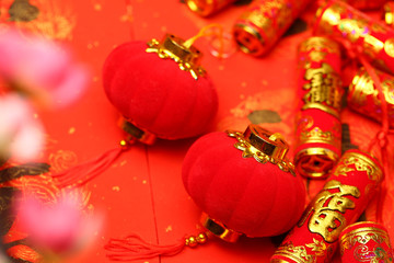 Fototapeta na wymiar Chinese new year lanterns and fake firecrackers on red background that says good luck and happiness