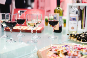 Naklejka na ściany i meble Alcohol bar, cocktail glass on bar counter, cocktail glass in a bar, Drinking cocktail in bar, cocktail in the glass with straws, Fresh drink coctail on a color background