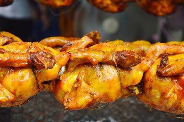 roasted chicken stabbing in iron and rolling on stove