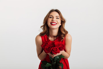 Portrait of a satisfied young woman dressed in red dress