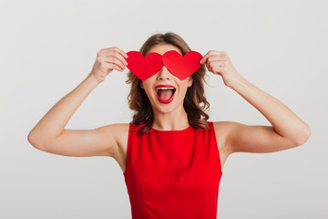 Portrait of an excited young woman dressed in red dress
