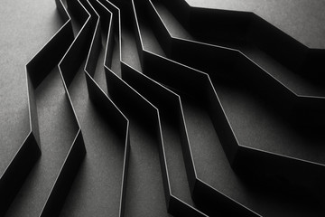 Abstract pattern made of black paper, dark background	