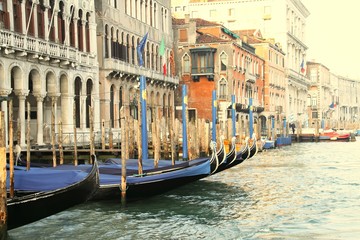 Fototapeta na wymiar Moored gondolas in a row on the Grand Canal in Venice Italy.