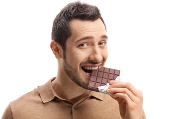 Young man eating chocolate