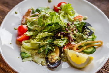 Tasty salad with seafood on a white plate