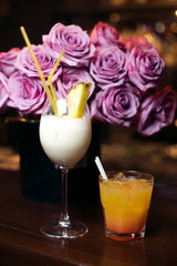 Alcohol bar, cocktail glass on bar counter, cocktail glass in a bar, Drinking cocktail in bar, cocktail in the glass with straws, Fresh drink coctail on a color background