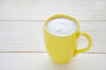 A cup of hot cappuccino coffee on the table